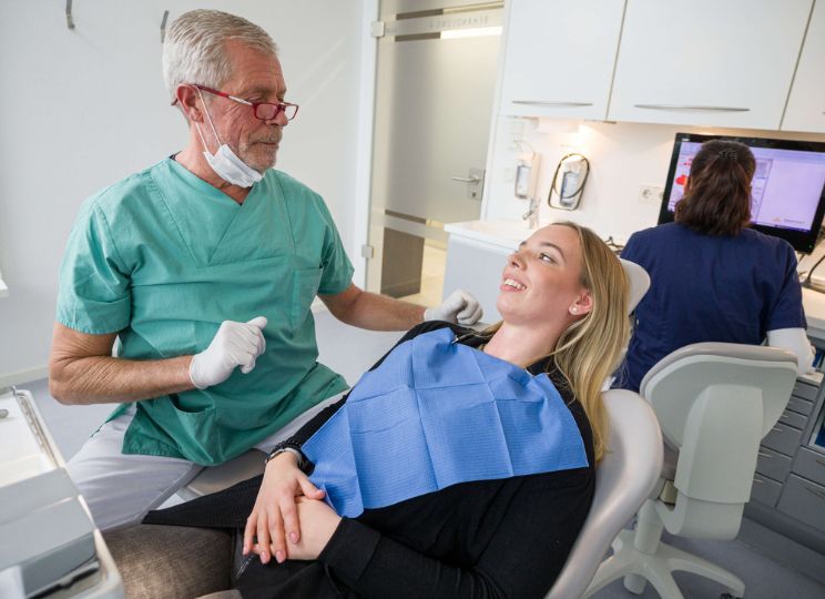 Clinician speaking with a relaxed patient in a treatment room