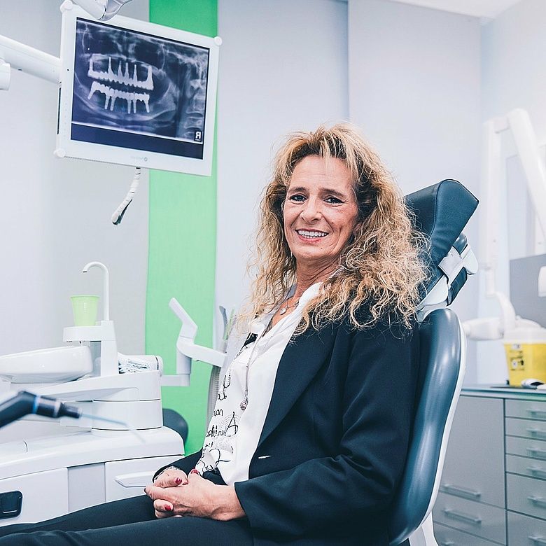 Patient in a modern treatment room during an implant consultation