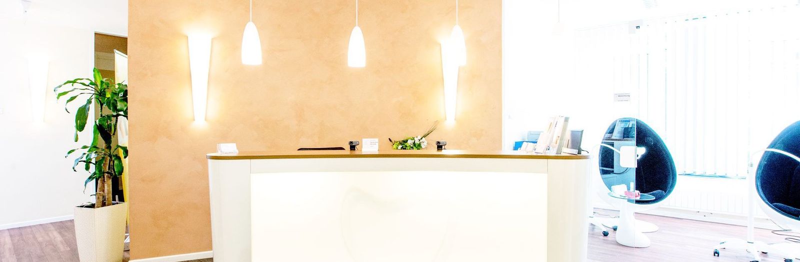 Bright clinic reception with limestone wall and calm waiting area